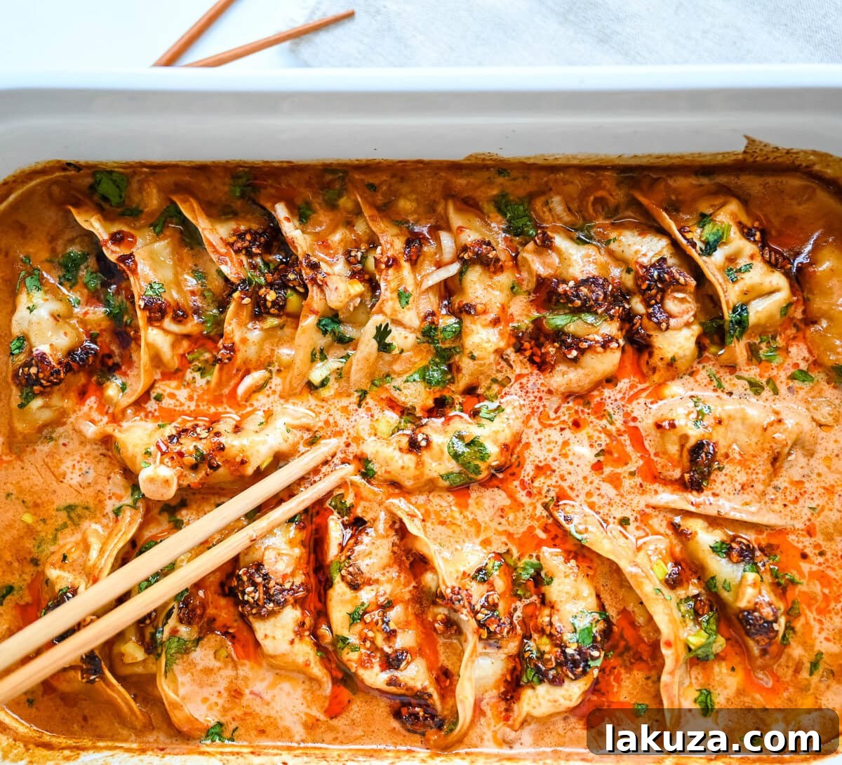 Golden Baked Dumplings 4 These viral baked dumplings from TikTok are the ultimate easy dinner hack! Crispy dumplings are baked in a creamy coconut curry sauce and topped with cilantro, chili crunch oil, and sesame seeds for the perfect mix of flavor and texture. This is an easy sheet pan dinner recipe!