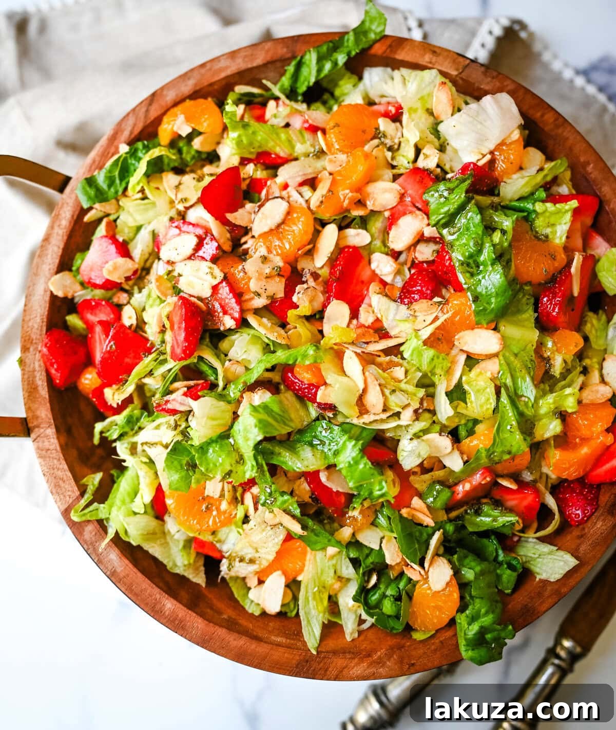 A beautifully presented Strawberry Mandarin Orange Salad with Candied Almonds on a serving platter