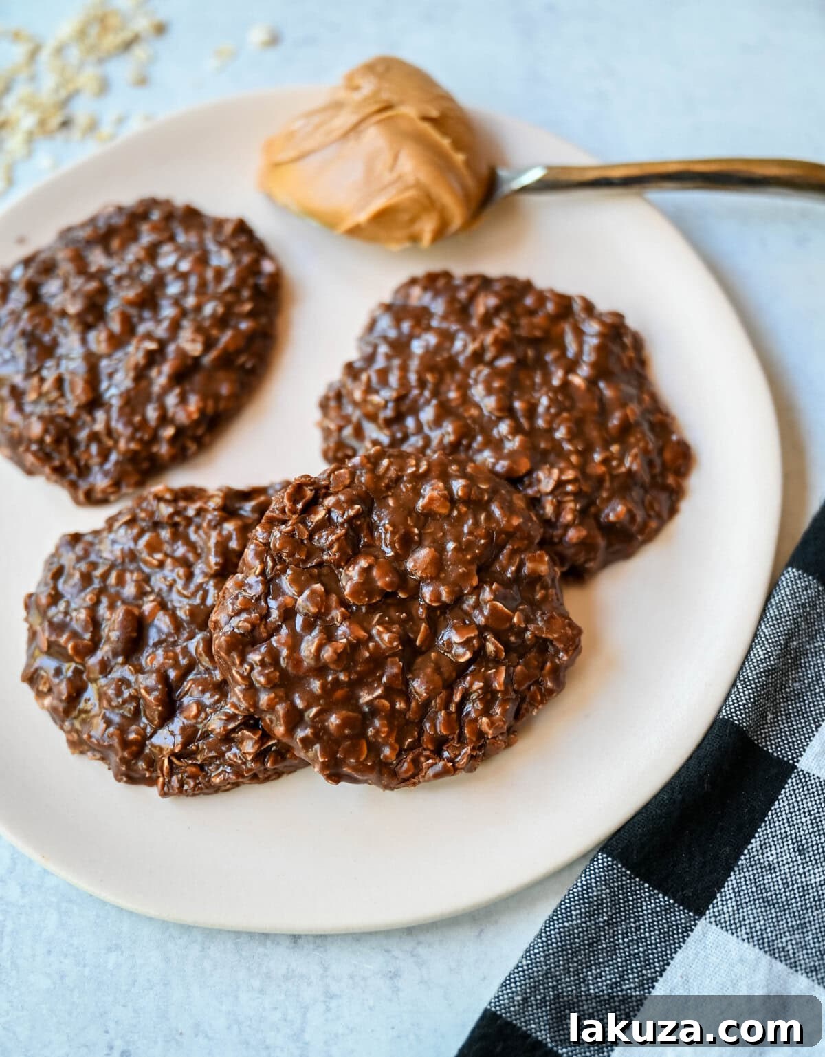 A vibrant overhead shot of the raw ingredients for no-bake cookies—butter, sugars, milk, cocoa, peanut butter, vanilla, and quick oats—arranged on a light surface, highlighting the simplicity of the recipe.