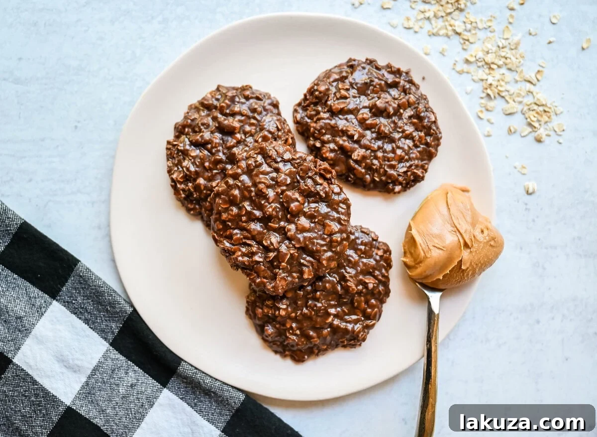 A close-up of a stack of perfect no-bake cookies, showcasing their inviting, chewy texture and rich chocolate peanut butter color, ready for a bite.