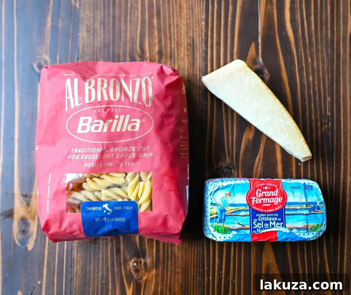 Close-up of the premium ingredients needed for an authentic Burro e Parmigiano: golden butter, a block of Parmigiano Reggiano, and uncooked pasta, promising an unparalleled comfort food experience.