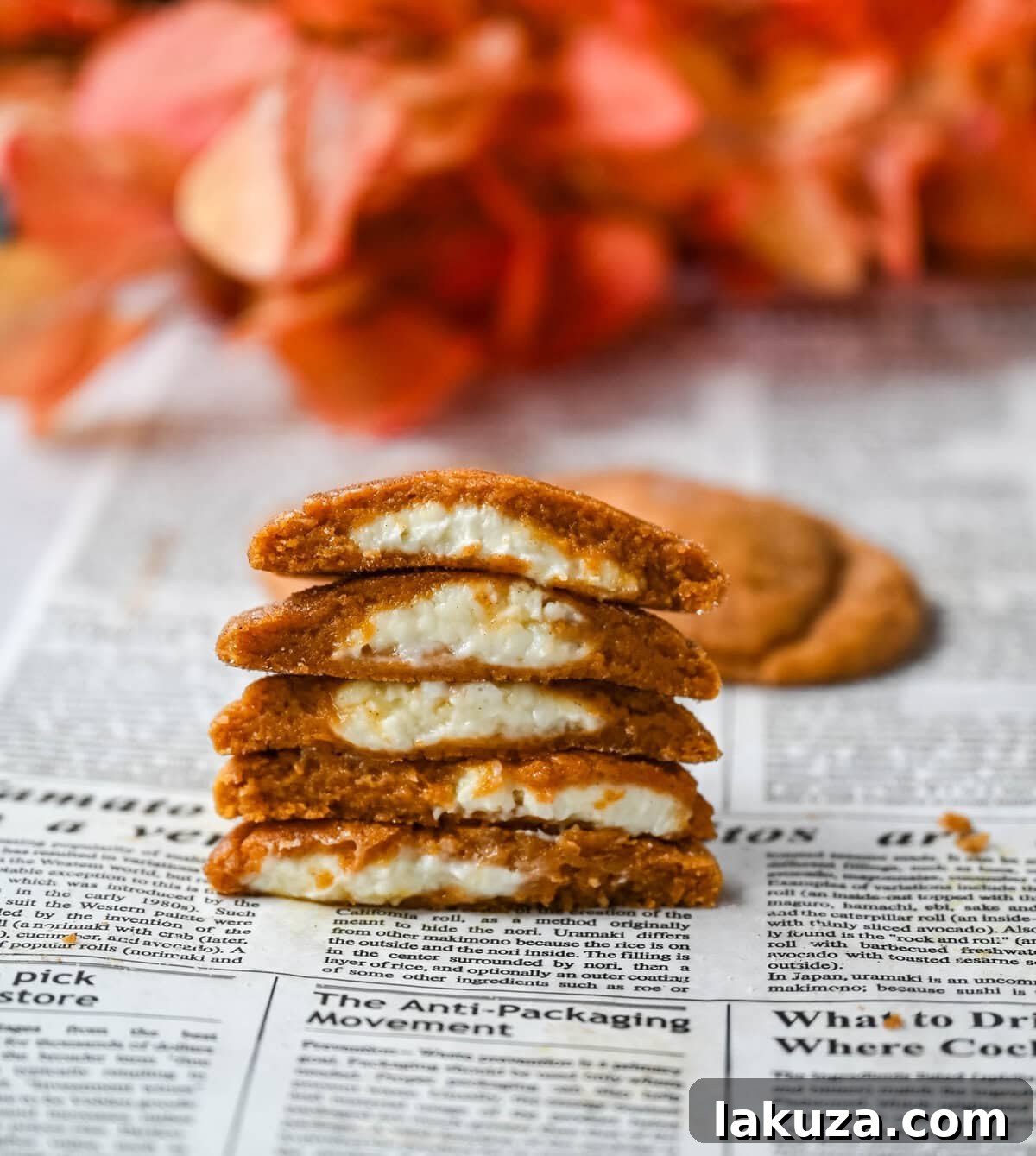 Freshly baked pumpkin cheesecake cookies cooling on a wire rack.