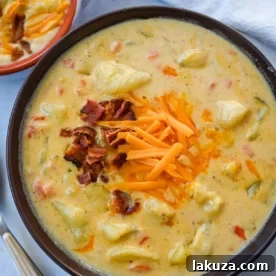 This creamy potato soup is the definition of comfort in a bowl made with buttery Yukon gold potatoes, crispy bacon, cheddar cheese, and a splash of heavy cream come together to make the richest, coziest soup ever. You will love this Potato Cheese Soup Recipe!