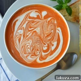 Creamy Tomato Basil Soup is the best cream of tomato soup. This Creamy Tomato Basil Soup Recipe using sauteed onions, garlic, tomatoes, chicken broth, basil, and heavy cream. You will never eat canned tomato soup again! The best creamy tomato soup recipe. www.modernhoney.com