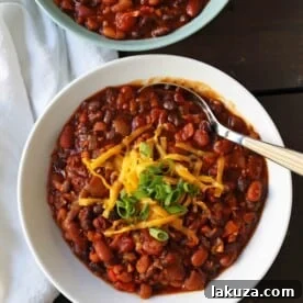 Veggie Chili Recipe. A healthy vegetable and bean filled chili in a spicy tomato sauce. The perfect Veggie Chili recipe and you won't even miss the meat! www.modernhoney.com #veggiechili #veggiechilirecipe #vegetarian #chili