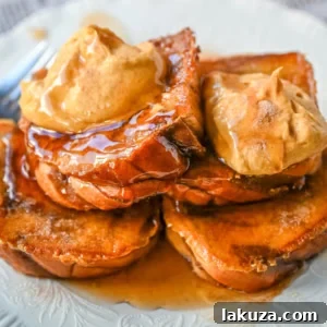 The ultimate Pumpkin French Toast, golden on the outside, soft inside, topped with sweet brown sugar pumpkin spice cream cheese. Perfect fall breakfast.