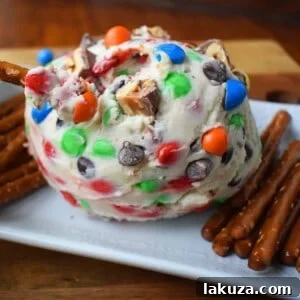 Decadent Candy Bar Cheeseball 6 Chocolate Candy Bar Cheese Ball by Modern Honey. A popular sweet cheese ball that is perfect for parties. Dip pretzels in sweet candy bar dip.