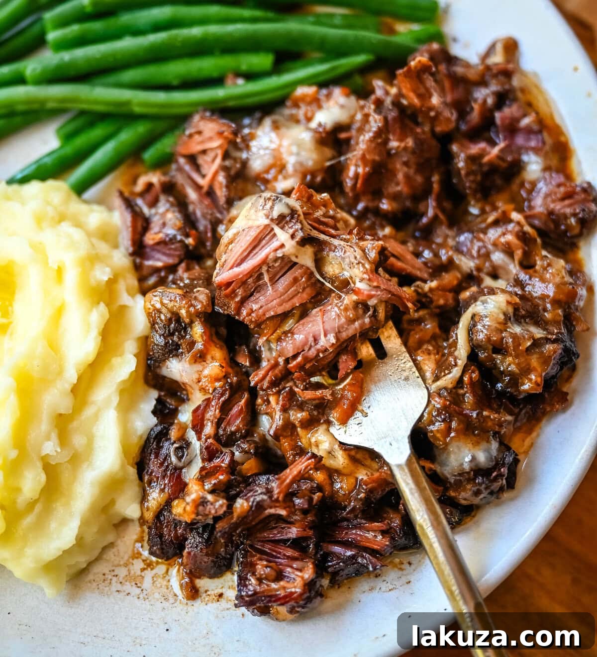 Slow-Cooked French Onion Beef Pot Roast 4 A pot of French Onion Pot Roast with melted Gruyère cheese on top.