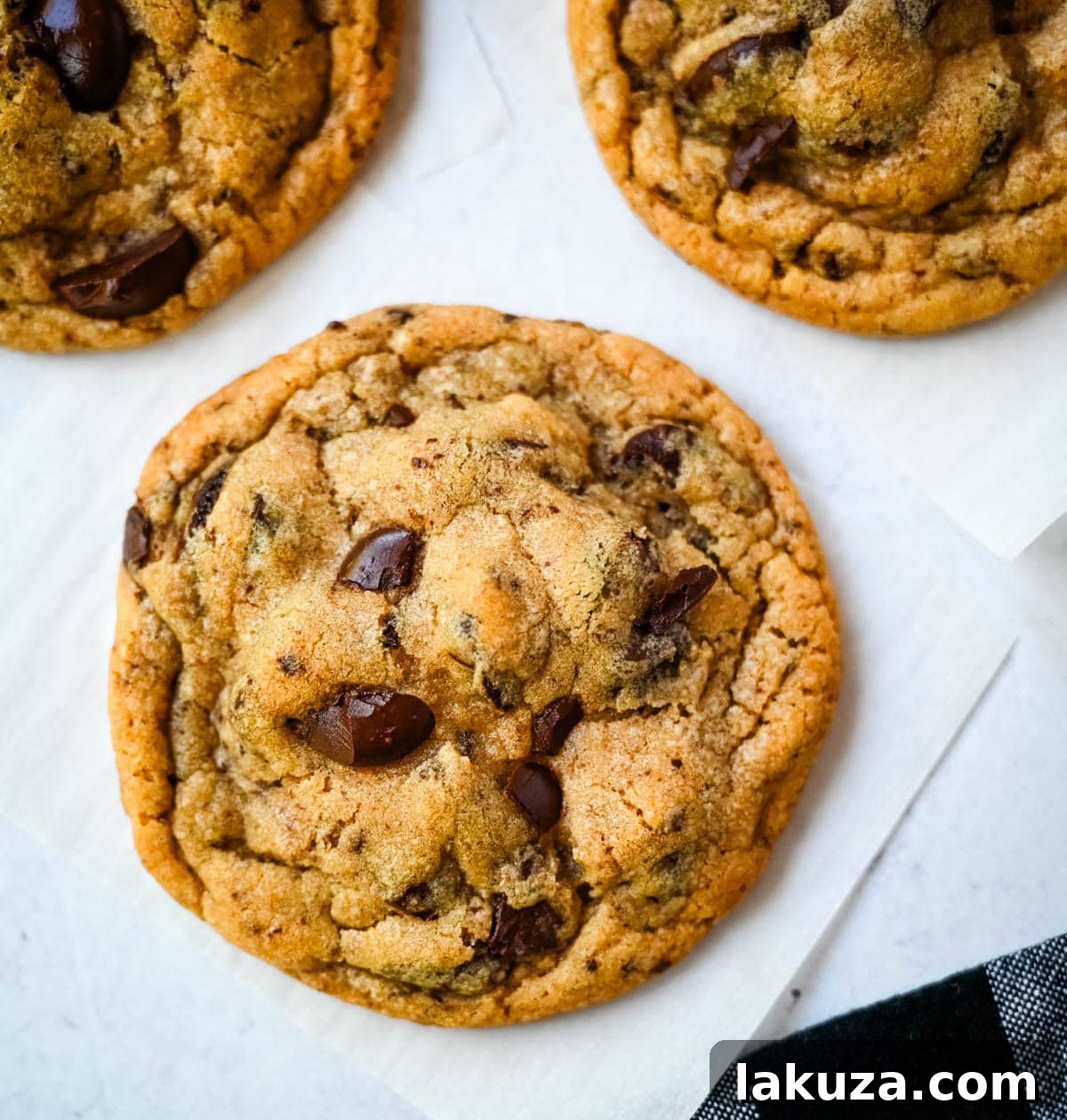 Freshly baked Jacques Torres chocolate chip cookies with golden edges and a soft center, ready to be enjoyed.