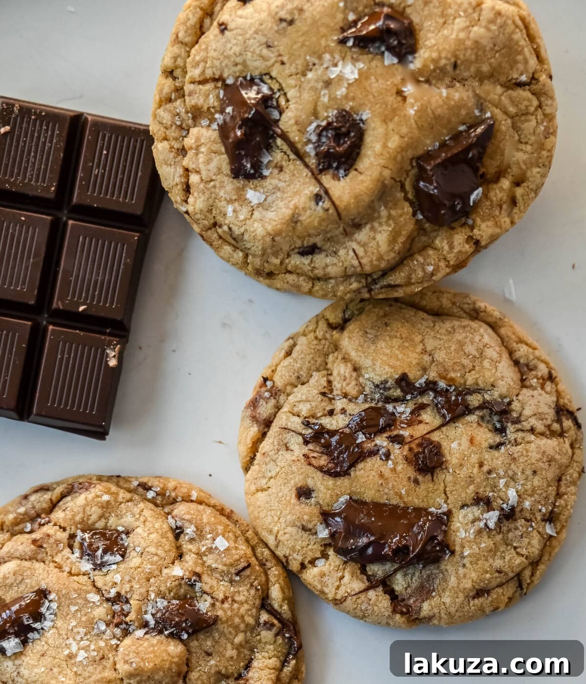 A stack of perfectly baked Jacques Torres chocolate chip cookies, highlighting their thick, chewy texture and abundant chocolate.