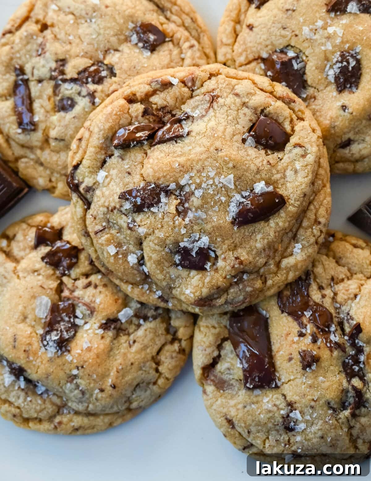 A beautifully presented Jacques Torres chocolate chip cookie, ready to be picked up and savored.