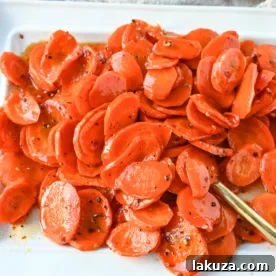 These Roasted Carrots with a Maple Brown Sugar Glaze are carrots roasted in butter, real maple syrup, brown sugar, and a touch of red pepper flakes. These maple glazed carrots are sweet and savory and a perfect side dish recipe.