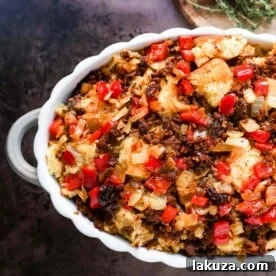 Mexican Chorizo Cornbread Stuffing made with cornbread tossed with sauteed peppers and onions, Mexican chorizo, chipotle peppers, chicken broth, cream, and spices. The most flavorful stuffing you will ever try!