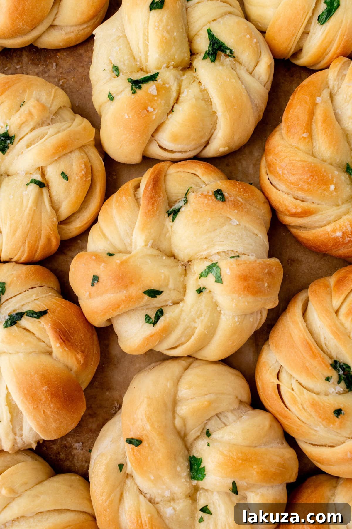Buttery, fluffy homemade rolls tied in knot and brushed with butter. The perfect knotted rolls recipe!