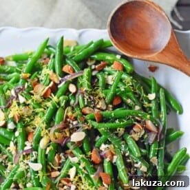Green Beans with Almonds and Caramelized Onions. Light and fresh green beans sauteed with caramelized onions, fresh lemon zest, and crunchy almonds. Perfect side dish for your holiday table. www.modernhoney.com