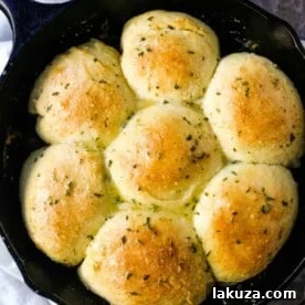 Homemade Garlic Butter Rolls. Made from scratch, fluffy homemade pull-apart rolls slathered in garlic herb butter. The perfect buttery homemade pull-apart rolls recipe! www.modernhoney.com #garlicbutterrolls #homemaderolls #rolls #dinnerrolls #pullapartrolls
