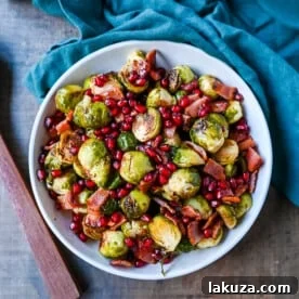 Roasted Brussels Sprouts with Bacon. These Roasted Brussels Sprouts are tossed in extra-virgin olive oil and spices and cooked until soft on the inside and crispy on the outside then drizzled with real maple syrup and served with crispy bacon and crunchy pomegranates. The perfect Fall and holiday side dish recipe.
