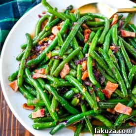This recipe for brown sugar bacon green beans brings a sweet and savory twist to traditional green beans with the addition of crispy bacon, caramelized onions, and a buttery brown sugar glaze. This easy side dish is perfect for holiday dinners, Thanksgiving or as crowd pleasing side dish, adding just the right amount of richness to fresh green beans while keeping them fresh and crisp-tender.