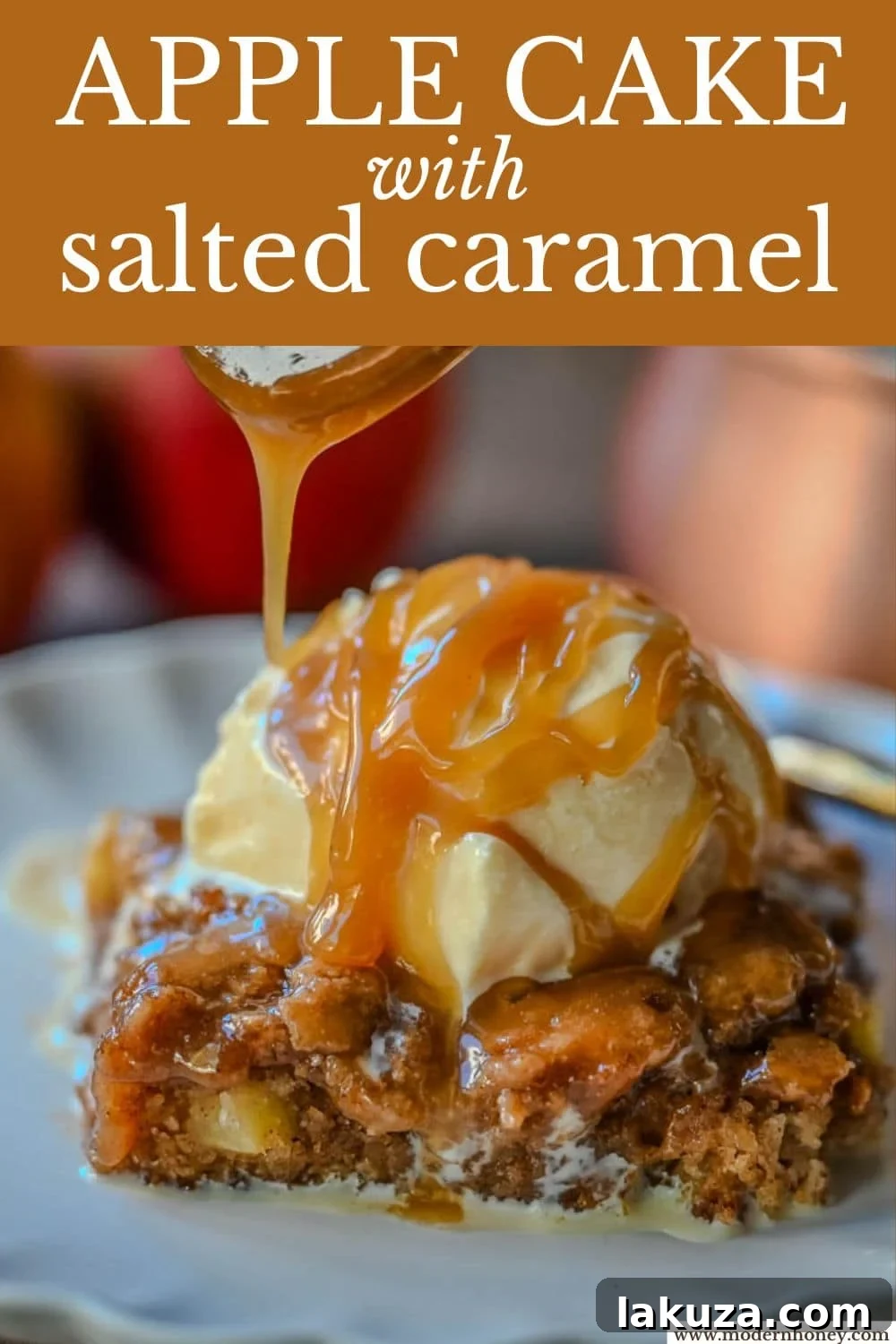 A side shot of a slice of Apple Cake with Salted Caramel, highlighting the layers of cake, apples, and the rich, golden caramel sauce.