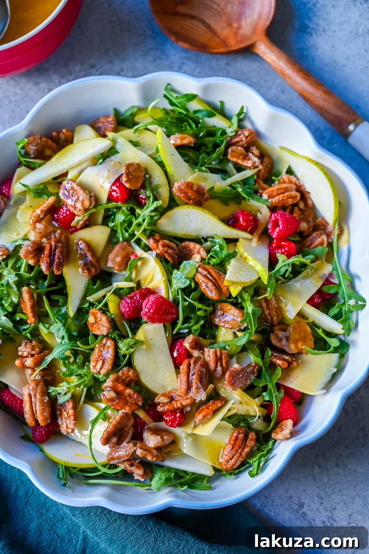 Arugula Pear Salad with Candied Pecans. A fresh and elegant salad featuring peppery greens, sweet pears, crunchy candied pecans, and savory Gouda cheese, all tossed in a zesty homemade lemon vinaigrette. Perfect for entertaining or a special weeknight meal.