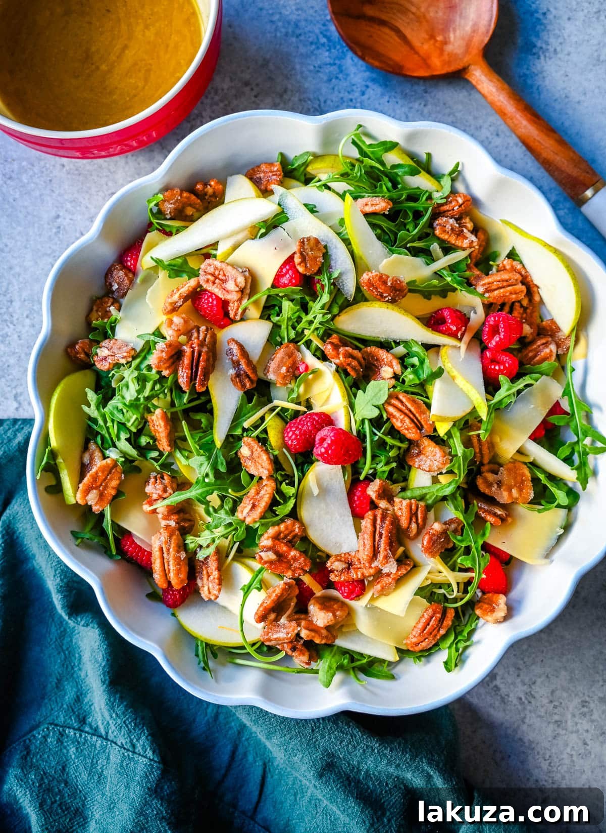 Close-up of Arugula Pear Salad with Candied Pecans, highlighting the texture of the greens, sliced pears, and glistening candied nuts.