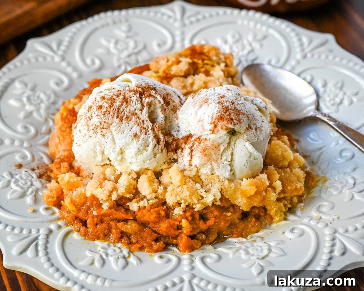Delicious Pumpkin Cobbler with a creamy spiced filling and buttery crumble topping, perfect for Fall and Thanksgiving.