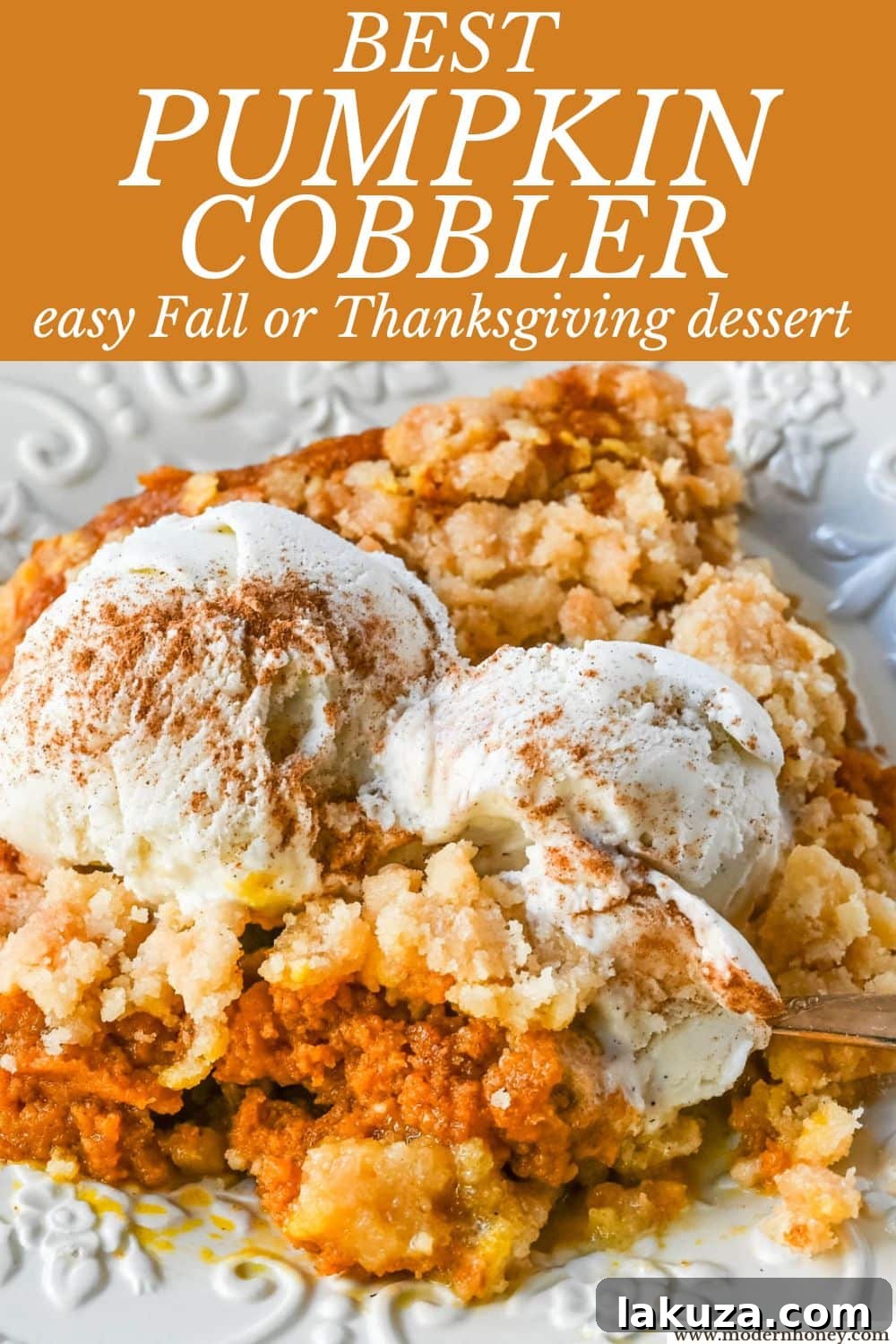 Close-up of a rustic pumpkin cobbler, showcasing the texture of the rich pumpkin filling and the golden crumble.