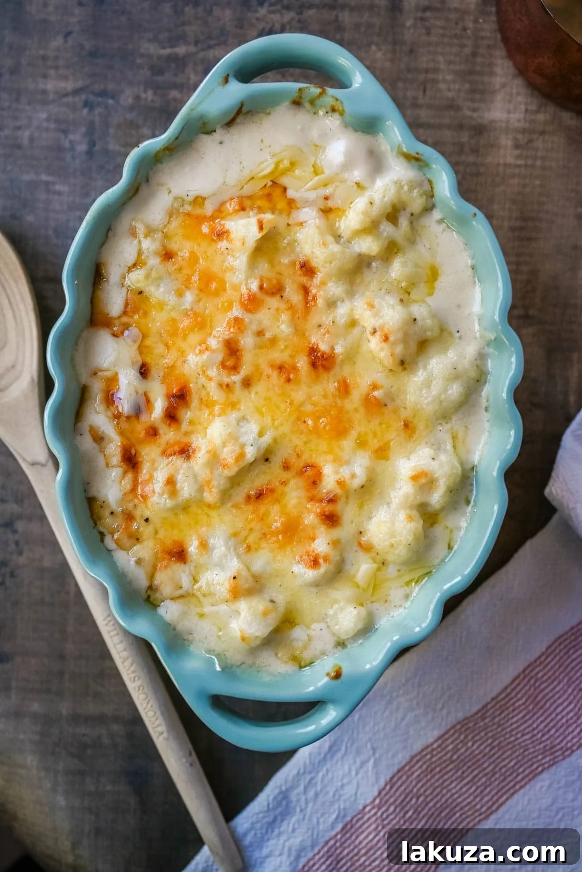Velvety Cauliflower Bake 3 Close-up of golden brown creamy cauliflower gratin, freshly baked with a bubbling cheese sauce.