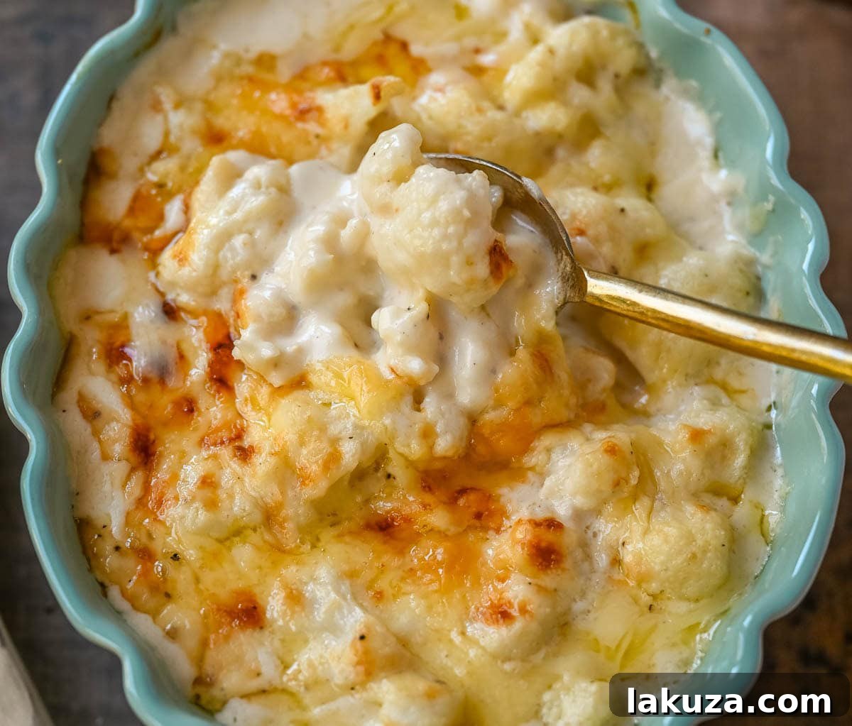 Velvety Cauliflower Bake 4 Raw ingredients for creamy cauliflower gratin laid out: cauliflower florets, shallots, garlic, cheeses, and butter.