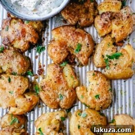 Crispy Smashed Potatoes. Crispy smashed potatoes with creamy, fluffy centers and crispy outsides. Petite potatoes topped with olive oil, salted butter, salt, and pepper and baked until crispy and topped with a garlic cheddar sour cream dip. The best smashed potatoes recipe!