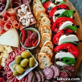Italian Charcuterie Board. A beautiful Italian Charcuterie board filled with Italian meats and cheeses and paired with sauces, fruits, and vegetables. Perfect to pair with your Italian meal.