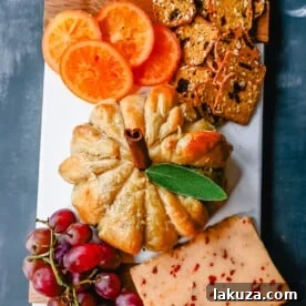 Pumpkin Shaped Baked Brie Puff Pastry. This festive Fall Pumpkin Baked Brie is the perfect appetizer or centerpiece for your charcuterie board. Flaky puff pastry baked with creamy brie cheese and pumpkin butter or fig jam is the perfect salty sweet combination.