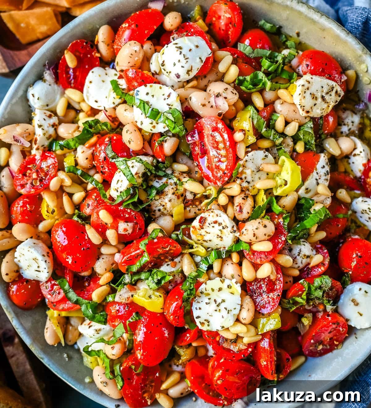 Close-up of fresh mozzarella pearls and vibrant tomatoes in Italian Cowboy Caviar.