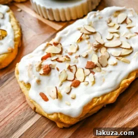 Homemade Swedish Pastry, also known as Danish Kringle, featuring a buttery crust, almond filling, and almond frosting, a rich and sweet holiday tradition.