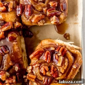 Caramel Pecan Sticky Buns, homemade sweet rolls filled with brown sugar cinnamon and topped with rich caramel sauce and pecans, noted as the best sticky bun recipe.