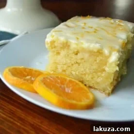 Orange Roll Breakfast Cake, a moist sweet orange cake with buttery orange topping and a sweet orange cream cheese glaze, perfect for holiday breakfast or dessert.