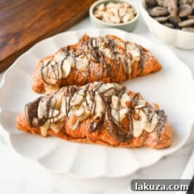 Easy Chocolate Almond Croissants, a quick shortcut recipe using day-old croissants filled with homemade almond filling and rich chocolate, baked until warm, declared as the best almond chocolate croissants.