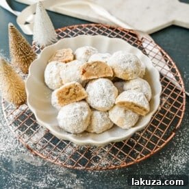 Mexican Wedding Cookies (Snowball Cookies). These buttery, nutty, Mexican wedding cookies are so easy to make and call for only 5 ingredients. These melt-in-your-mouth cookies are perfect to make during the holidays and everyone loves them. The perfect Christmas cookie recipe. A festive Christmas cookie.