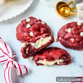 Cheesecake stuffed Red Velvet Cookies with white chocolate chips and a creamy cheesecake center are the perfect Christmas cookie. A vibrant red velvet cookie meets a creamy cheesecake center, with bursts of sweetness from white chocolate chips in every bite.