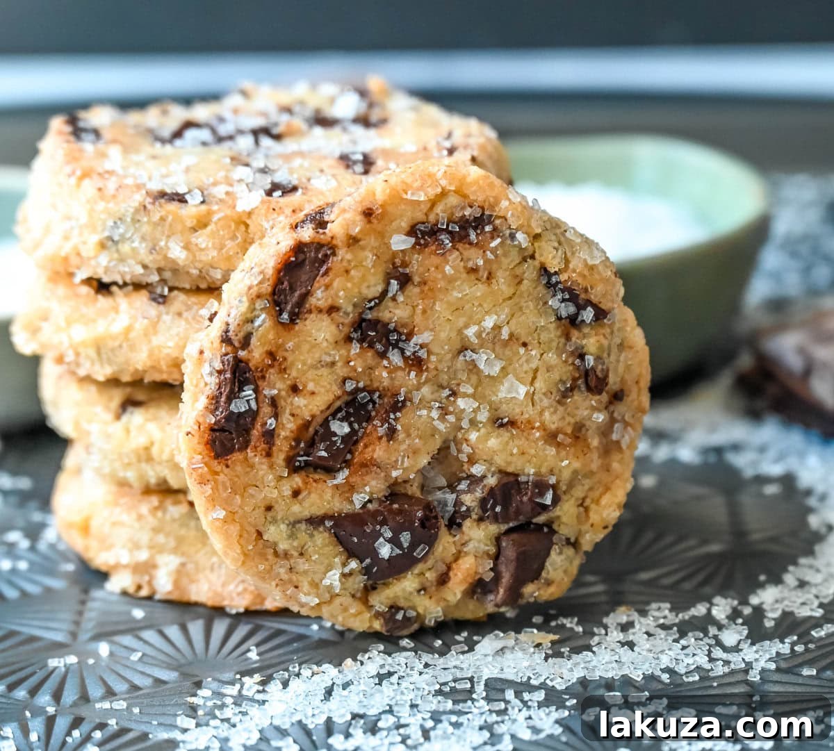 Salted chocolate chunk shortbread cookies are a twist on the classic chocolate chunk cookie, combining buttery, crumbly shortbread with rich chocolate chunks and a hint of flaky sea salt. These chocolate chip shortbread cookies are a perfect balance of sweet, salty, and savory flavors with a melt-in-your-mouth texture.