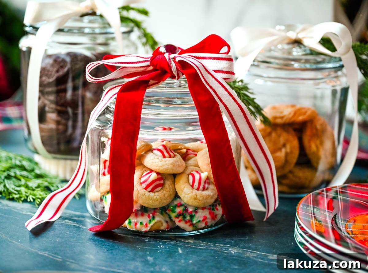 How to make cute glass Christmas cookie jars to give to neighbors, friends, family, and co-workers. It is such a cute way to package cookies. These are Anchor hocking glass jars and perfect for filling with homemade cookies. This is a perfect way to package Christmas cookies.