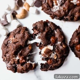 These Levain Bakery Rocky Road Cookies are rich, thick, soft, chewy chocolate cookies with semi-sweet chocolate chips, mini marshmallows, and cashews. The best Levain Bakery Copycat Rocky Road Cookie Recipe!