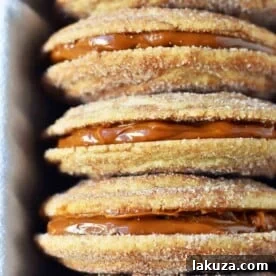 Dulce de Leche Cinnamon Sandwich Cookies. Cinnamon sugar snickerdoodles cookies stuffed with buttery dulce de leche caramel. A cinnamon sugar caramel cookie. www.modernhoney.com