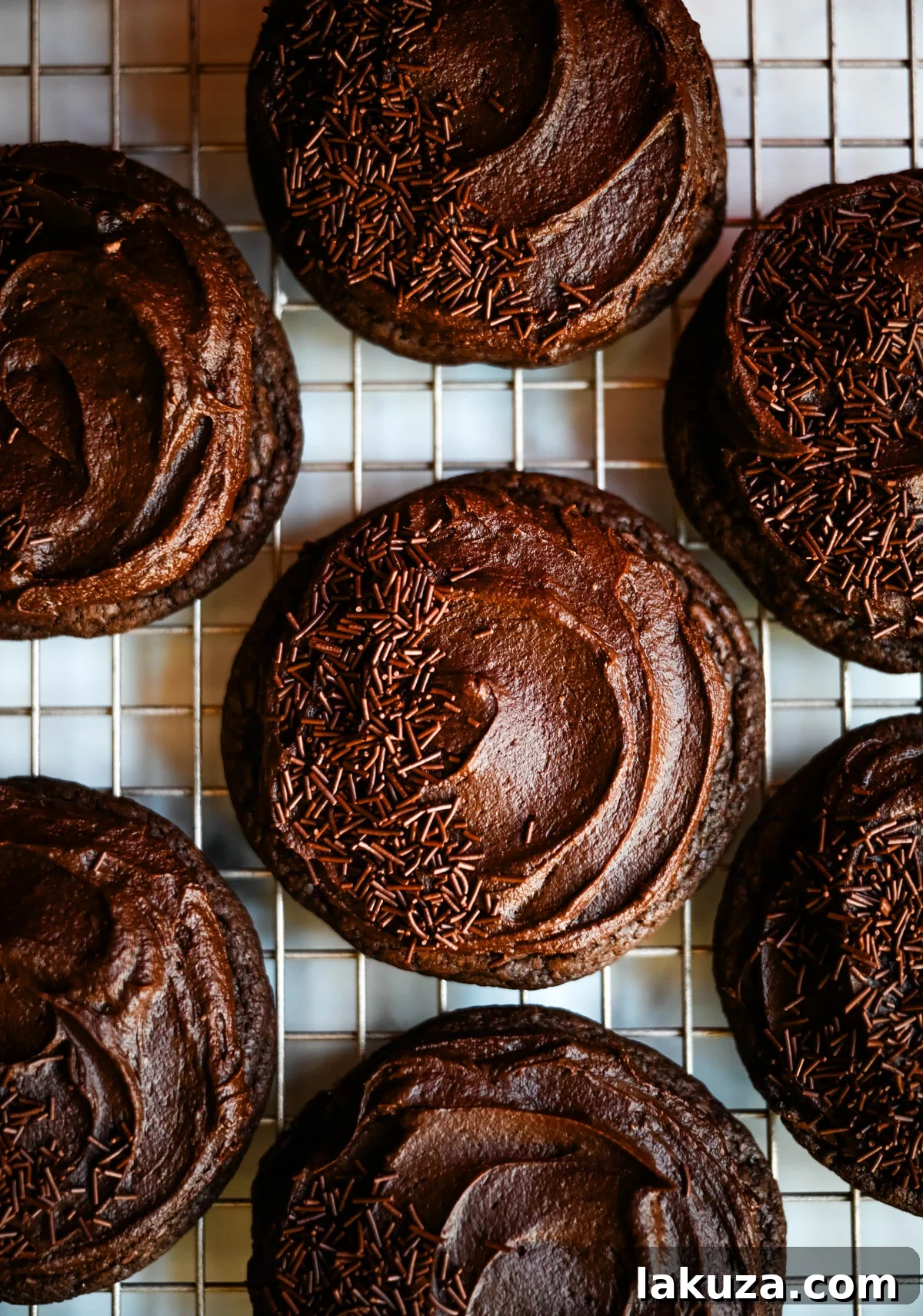 Chocolate Frosted Cookies with a festive sprinkle topping, perfect for holidays.