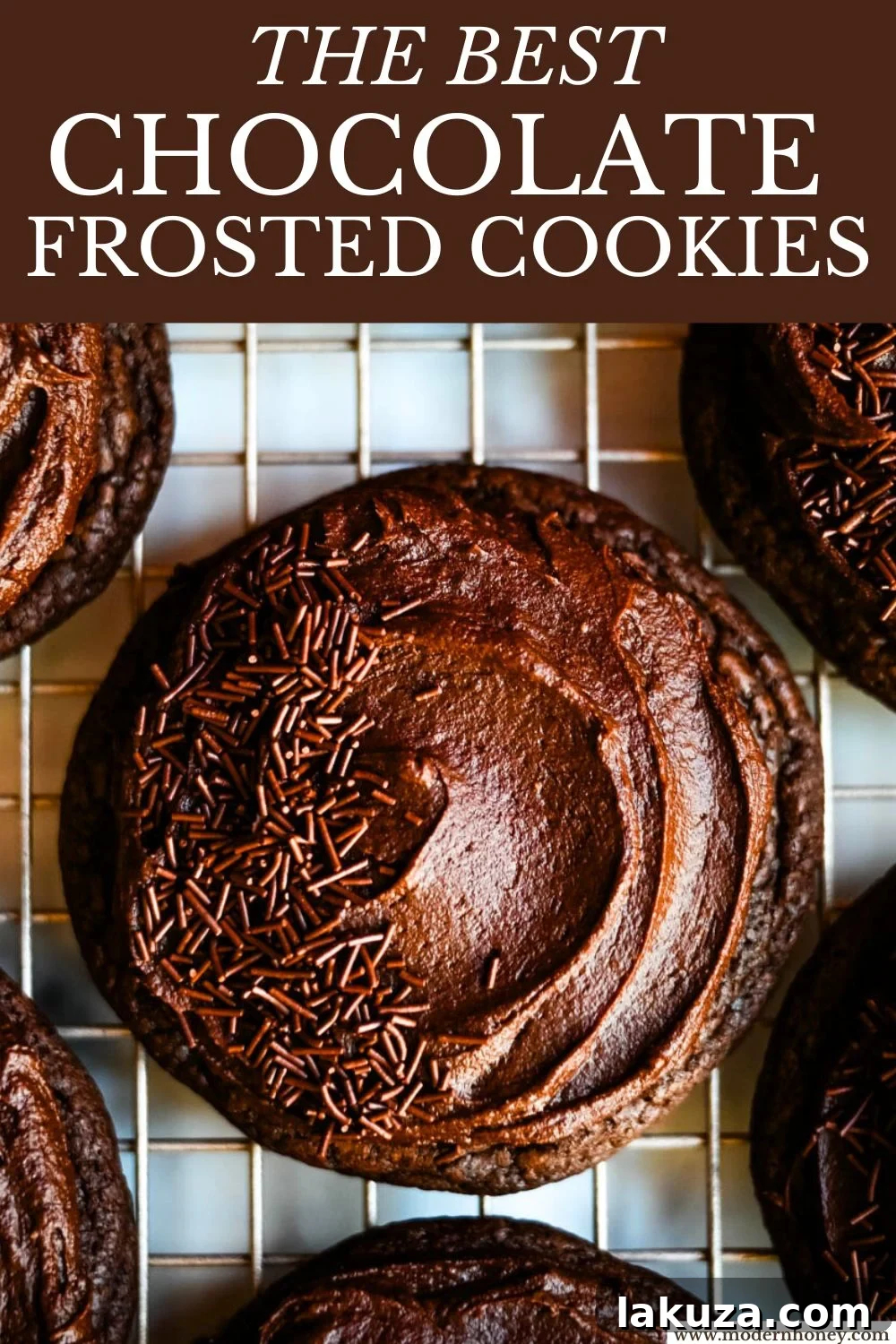 A stack of Chocolate Frosted Cookies, garnished with chocolate shavings.