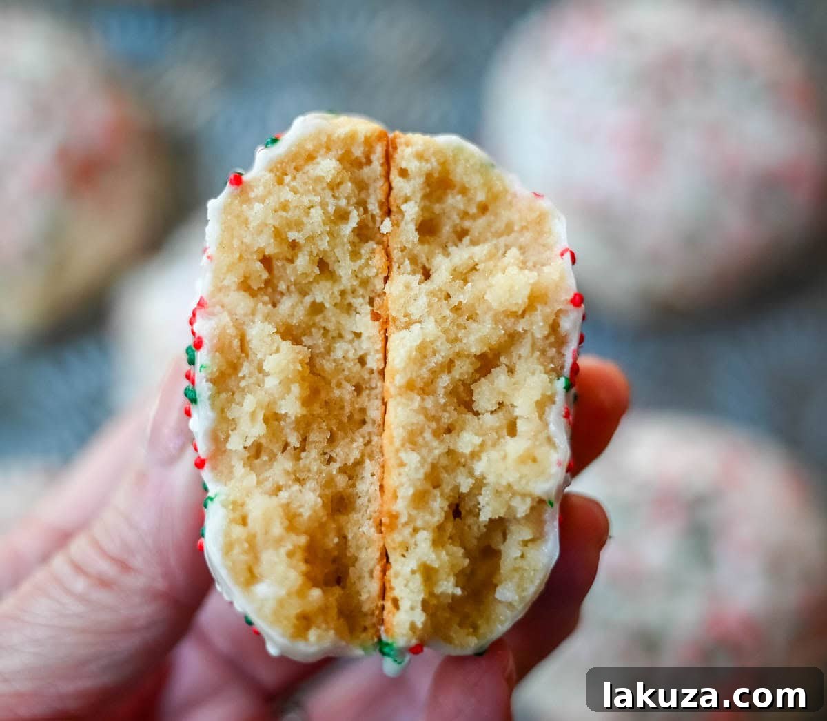 A vibrant assortment of glazed Italian ricotta cookies with various sprinkles, arranged artistically for a festive holiday display.