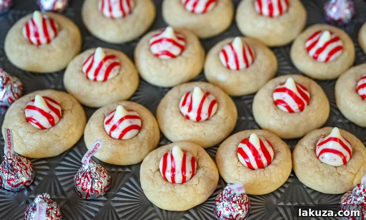 Holiday Candy Cane Kiss Delights 4 Ingredients for Candy Cane Kiss Cookies laid out on a kitchen counter: butter, sugar, eggs, extracts, flour, leavening agents, and Hershey's Kisses.