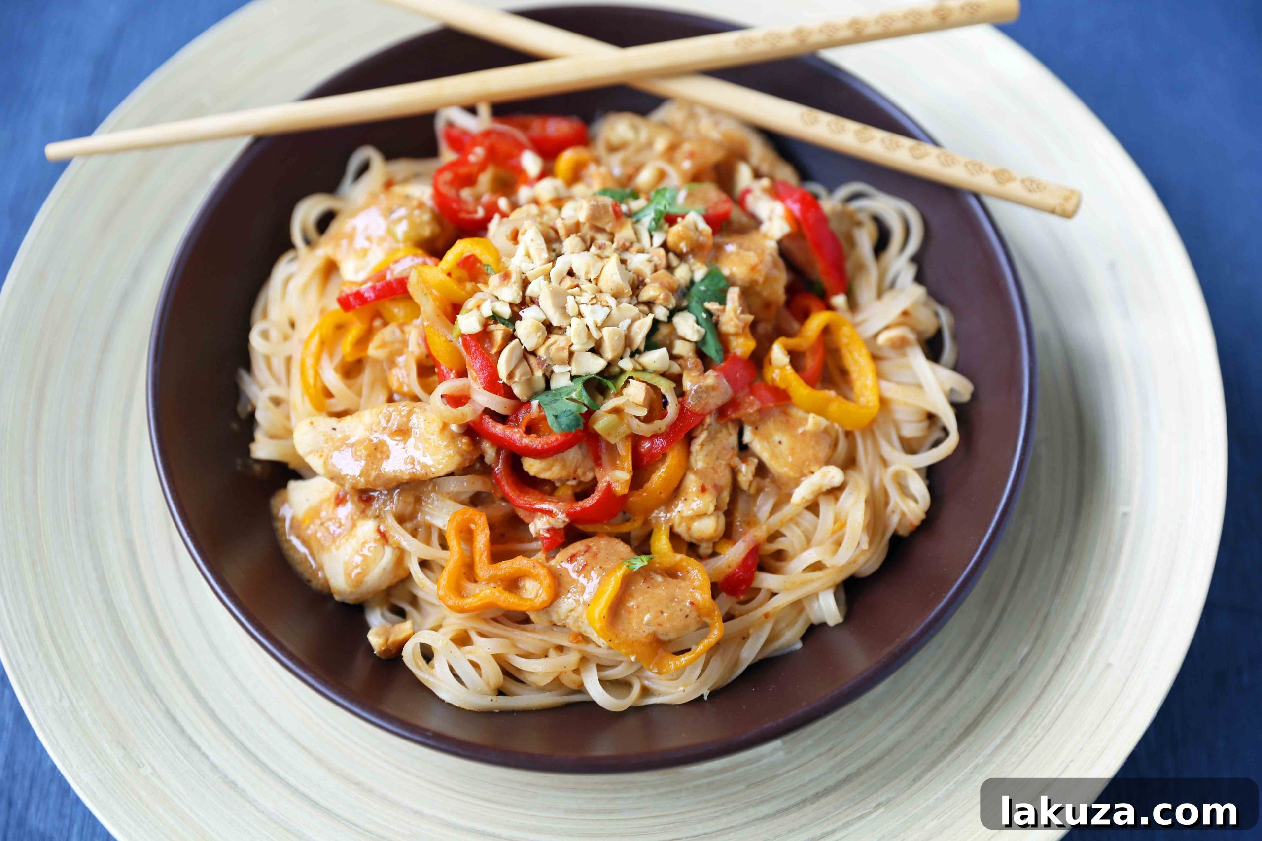 Flavorful Thai Chicken Noodles 3 Close-up of healthy Thai Chicken Noodles with colorful peppers and succulent chicken coated in a light peanut butter sauce. A perfect gluten-free and dairy-free dinner option from Modern Honey.