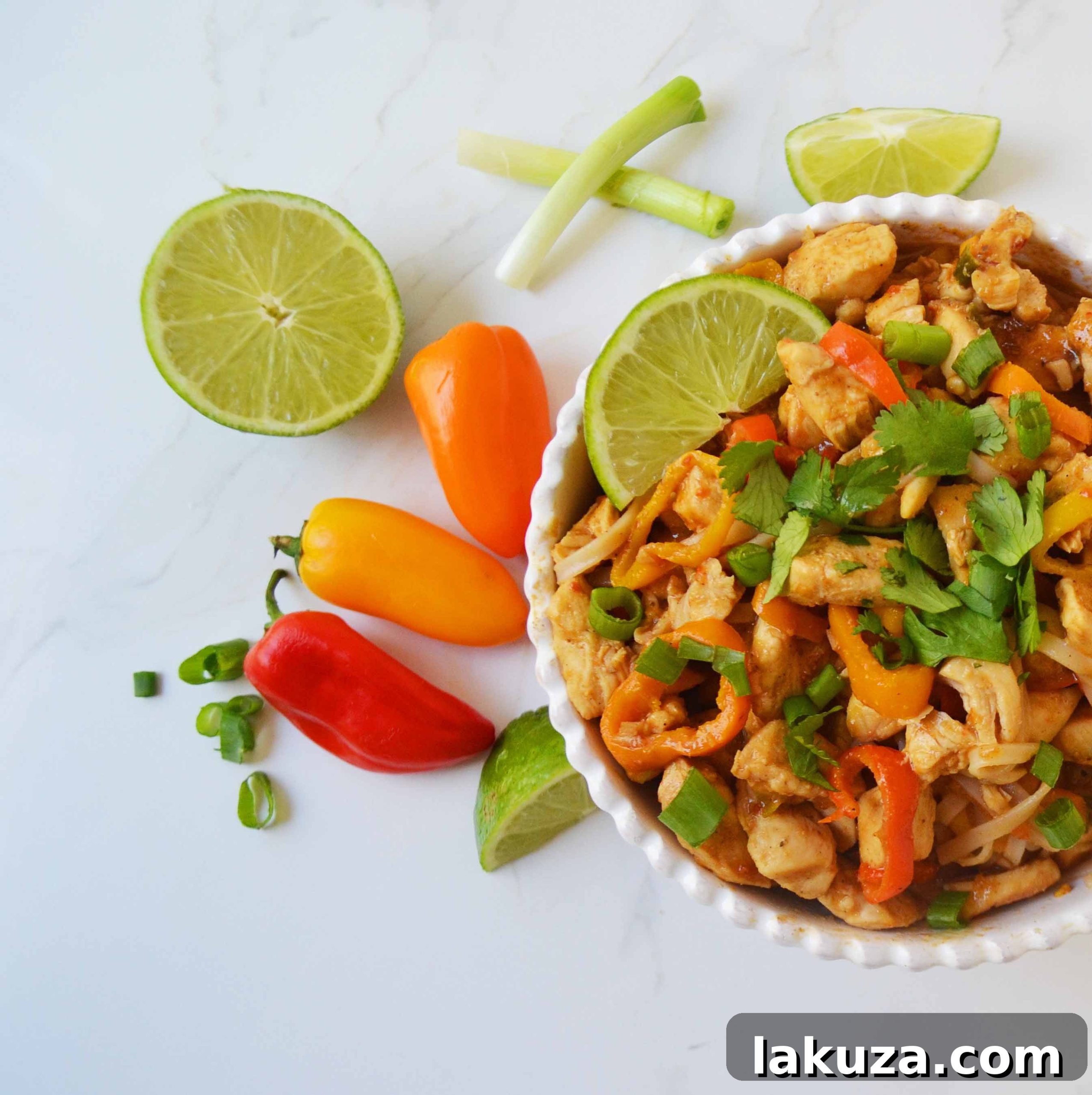 Flavorful Thai Chicken Noodles 7 A top-down view of Thai Chicken Noodles, highlighting the generous amount of sauce and fresh garnishes. A perfect dish to pin and share with friends.