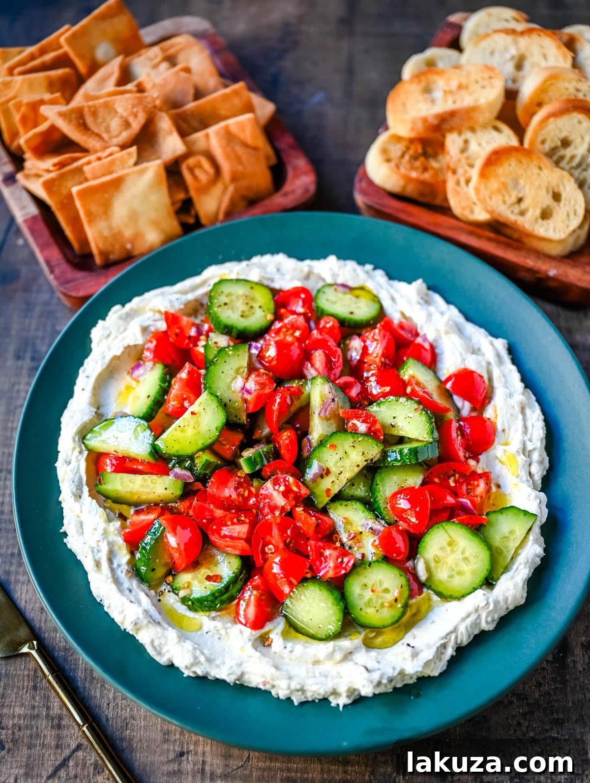 This Greek feta dip is the ultimate party and holiday appetizer that is rich, creamy, and so flavorful! It blends tangy feta, cream cheese, lemon, oregano, and olive oil into a silky whipped dip that feels fancy but takes just minutes to make. Pile it high with tomatoes, cucumbers, and a drizzle of olive oil, then serve with pita chips or veggies.